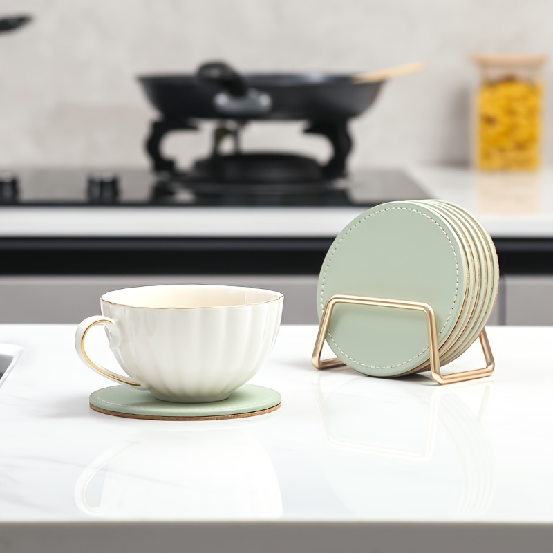 6 faux leather coasters with metal stands and cork bases